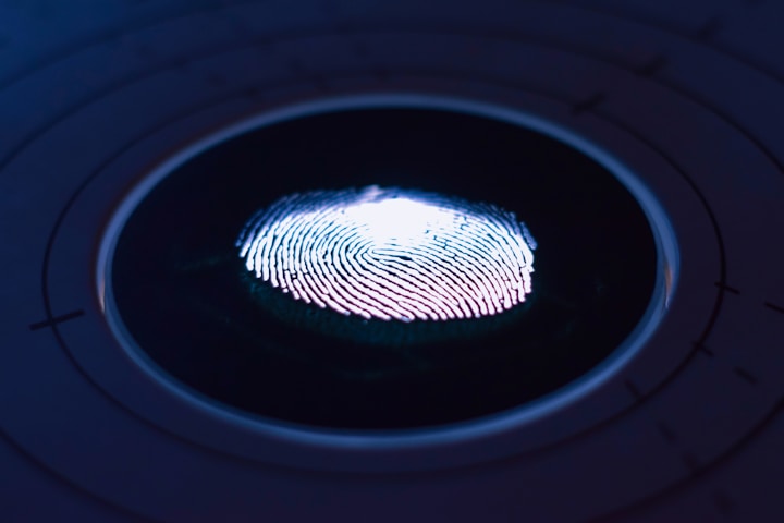 Glowing fingerprint scanner on a dark blue surface