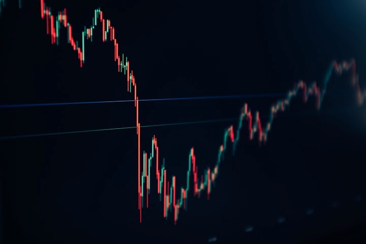 Candlestick price chart glowing on a dark screen